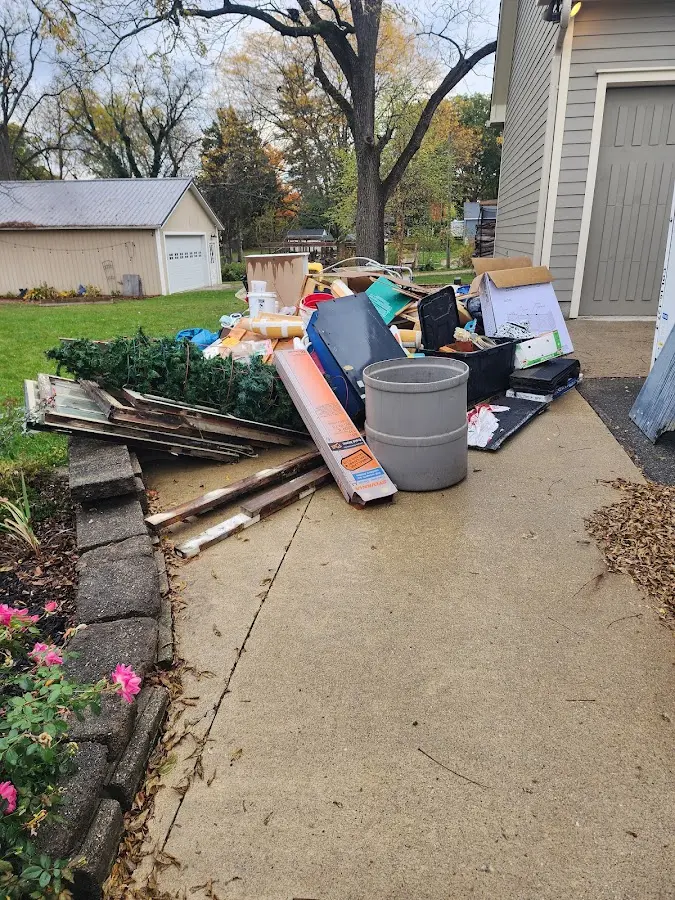 Dumpster being loaded with debris for Roofing Dumpster Rental in Conklin